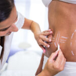 Woman receiving body contouring and liposuction services